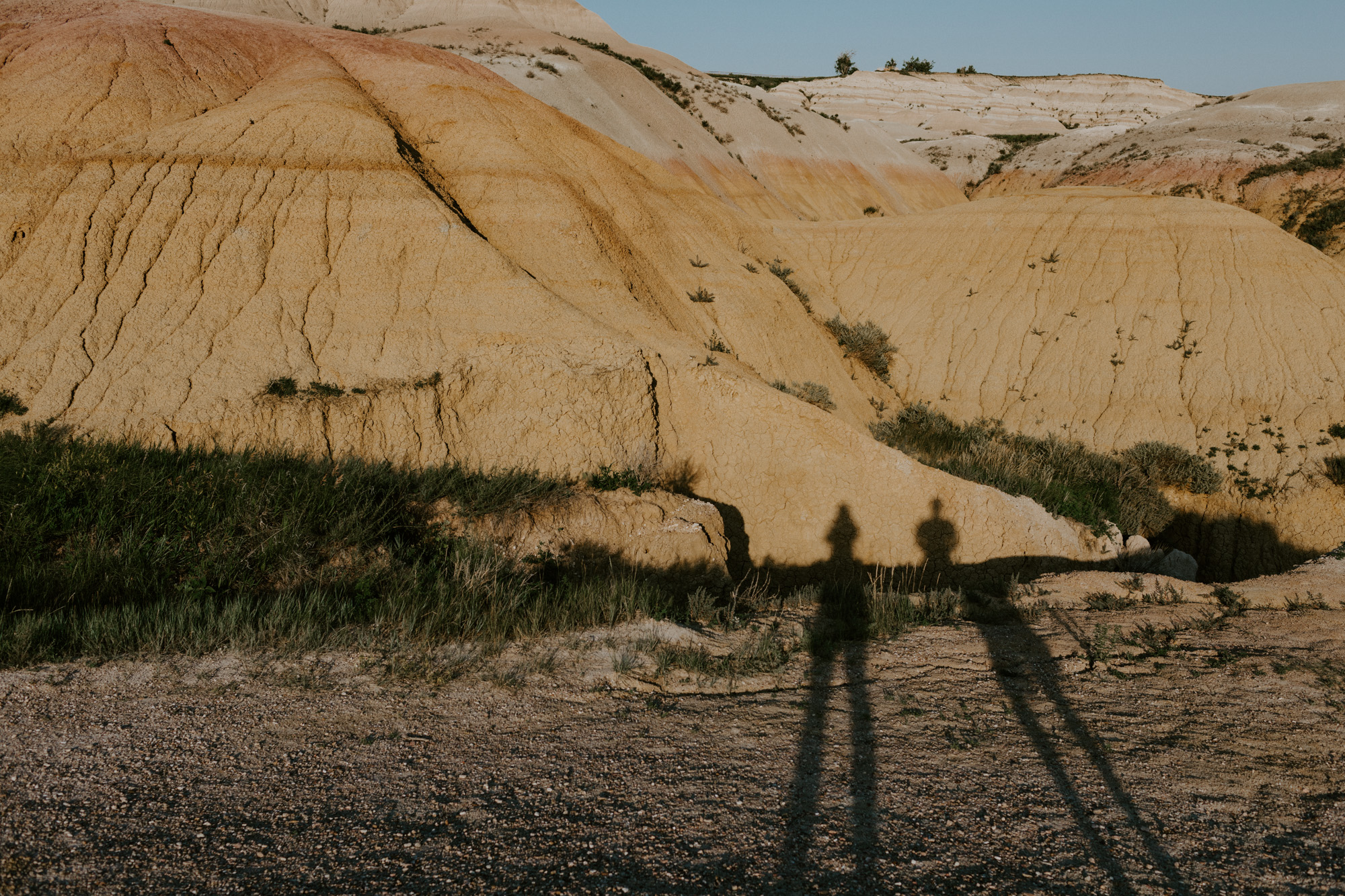 silhouette of a couple against yellow rock formations at Badlands National Park